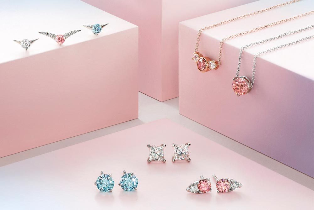 White, blue and pink lab grown diamond jewellery pieces by Lightbox Jewelry. Photo: De Beers