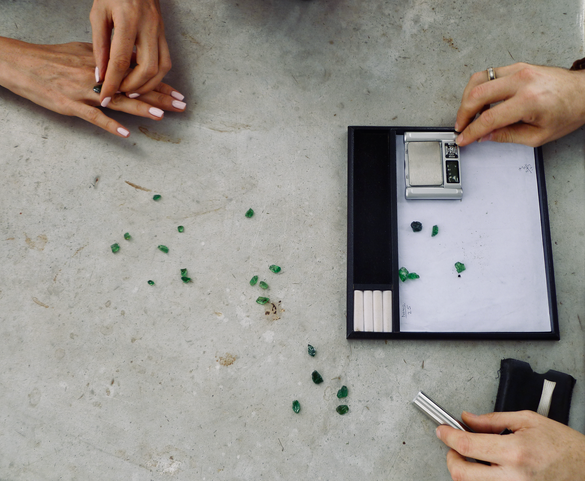 Gemmologists assess the tsavorite for sale at the sites